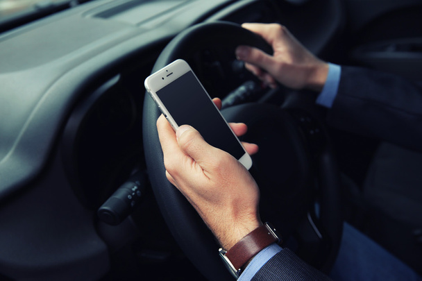 driver using smart phone in car - 写真・画像