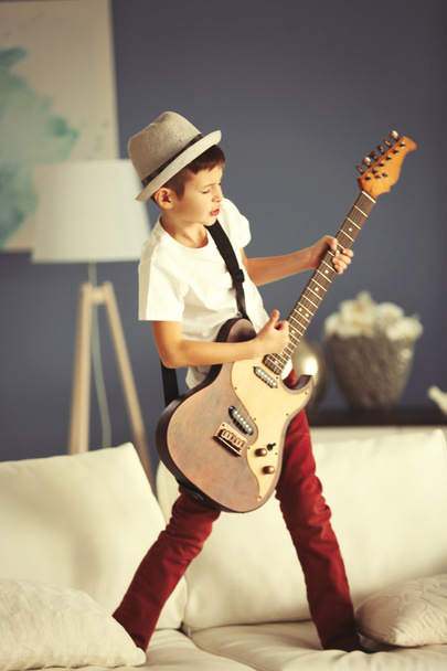 Kisfiú gitározik.   - Fotó, kép