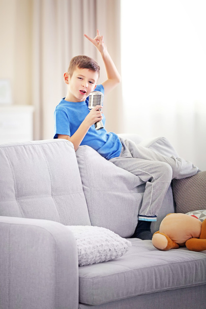Little boy singing with microphone  - Фото, изображение