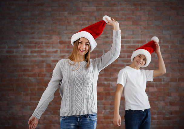 Happy cousins have fun  in santa hat - Фото, зображення