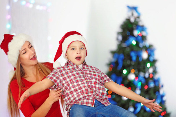 Girl and boy playing in decorated Christmas room - Foto, Imagen