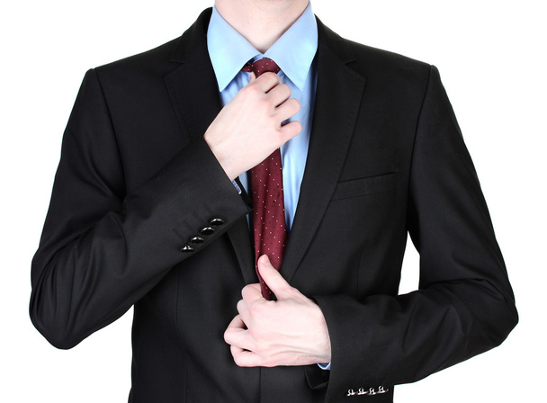 Businessman correcting a tie close up - Zdjęcie, obraz
