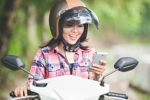 Young Asian woman riding a motorcycle - Fotoğraf, Görsel