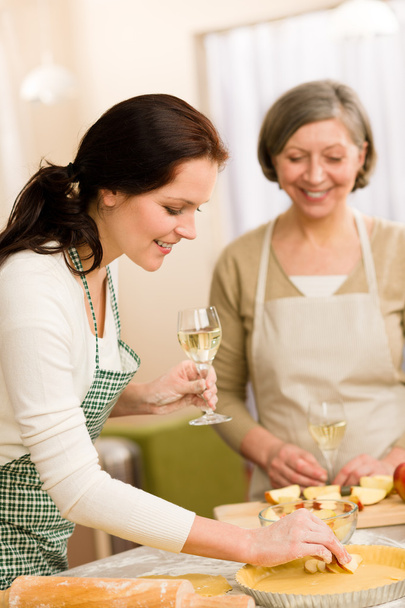 Two happy women enjoy baking apple pie - Foto, imagen