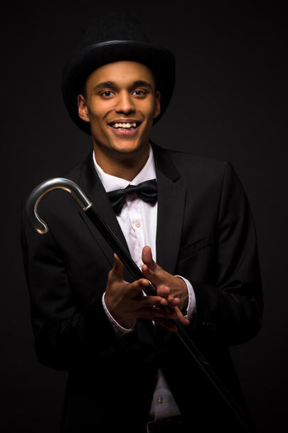 Handsome man in top hat posing with cane - Photo, Image