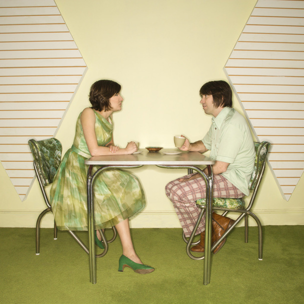 Couple sitting at table. - Fotoğraf, Görsel