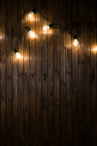 Light bulbs on dark Wooden Background real image - Foto, afbeelding