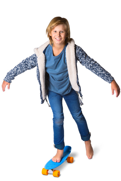Cute blonde boy or teenager in full length casual style blue jeans posing with skateboard pennyboard isolated on white - Fotoğraf, Görsel