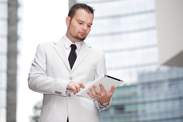 businessman typing on digital tablet - Fotó, kép