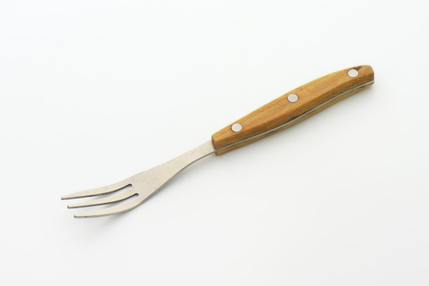Tenedor de tres puntas con mango de madera
 - Foto, Imagen