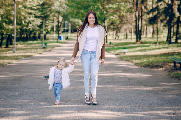young family walking in the park - Фото, изображение