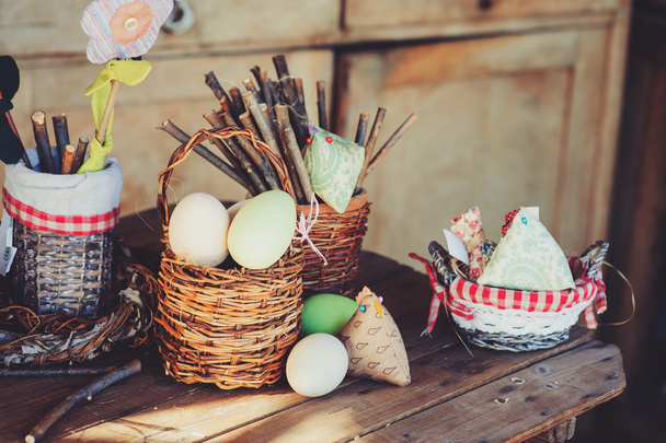 easter eggs and decorations on wooden table in cozy country house, vintage toned - Foto, Imagen