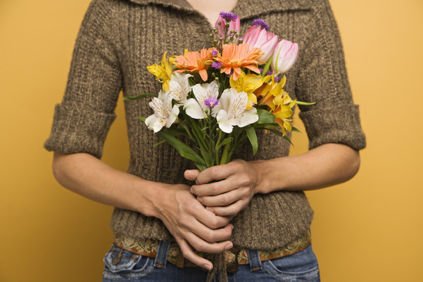 Woman holding flowers. - Foto, imagen