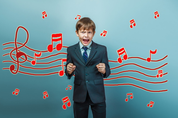 adolescent boy clenched his fists and yelling music notes sketch - 写真・画像