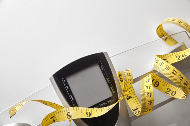 Concetto di nutrizione e controllo del peso con bilancia e nastro adesivo
 - Foto, immagini