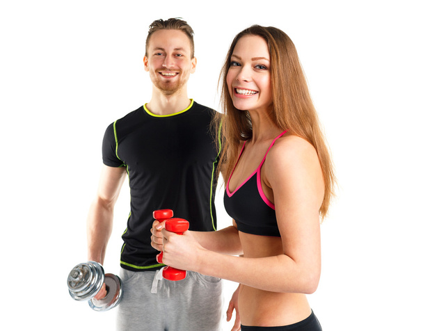athletischer Mann und Frau mit Hanteln auf dem weißen - Foto, Bild