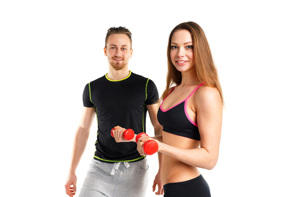 Atletik erkek ve kadın üzerinde beyaz dumbbells ile - Fotoğraf, Görsel