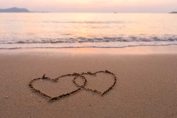 Два сердца, нарисованные на пляже
 - Фото, изображение