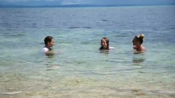 Mother and daughters playing in the tropical sea - Footage, Video