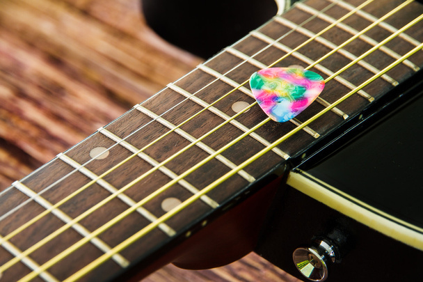 Acoustic guitar black color and plastic pick - Photo, Image