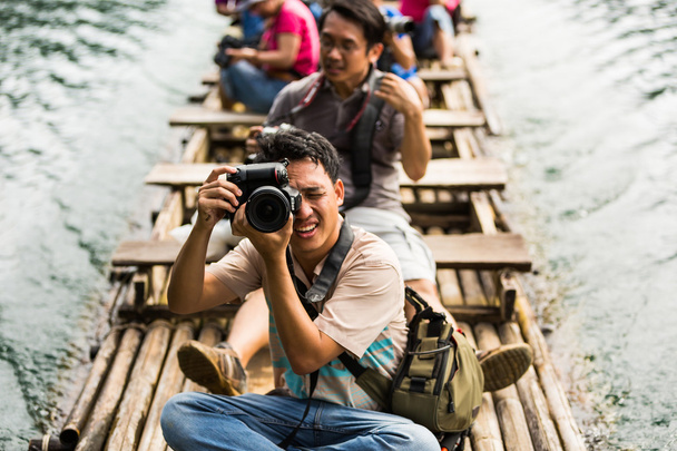 Taking photo while travel on bamboo raft - Photo, Image
