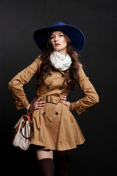 Woman wearing brown overcoat and cap blue - Foto, Imagen