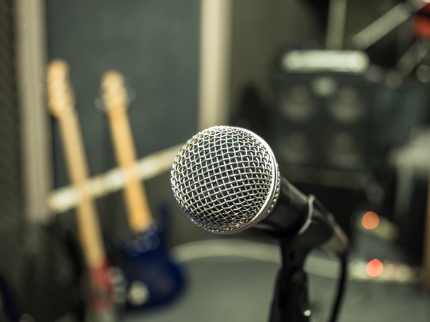 Selective focus on microphone with blurry music studio backgroun - Foto, Imagen