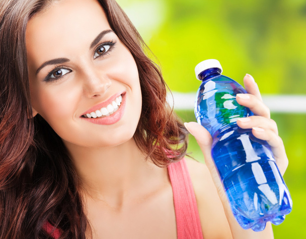 young happy woman with bottle of water - Foto, imagen