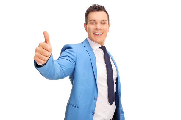 man in a blue suit giving a thumb up - Фото, изображение