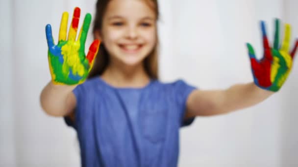 smiling girl showing painted hands - Materiał filmowy, wideo