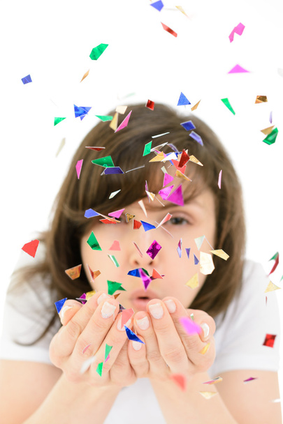 Young woman blows confetti with palms - Foto, Imagen