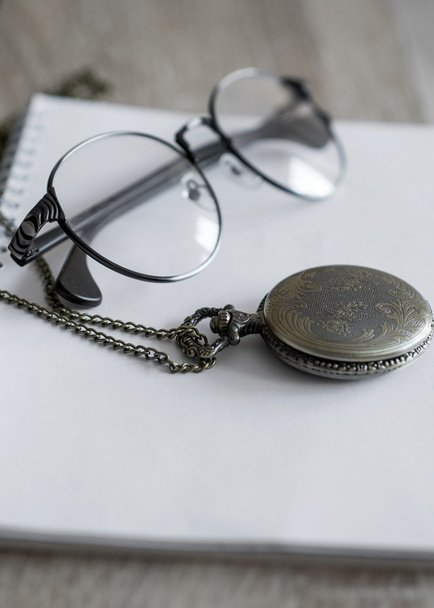 Old pocket watch and glasses  - Фото, зображення