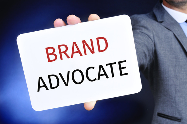 businessman shows a signboard with the text brand advocate - Photo, Image