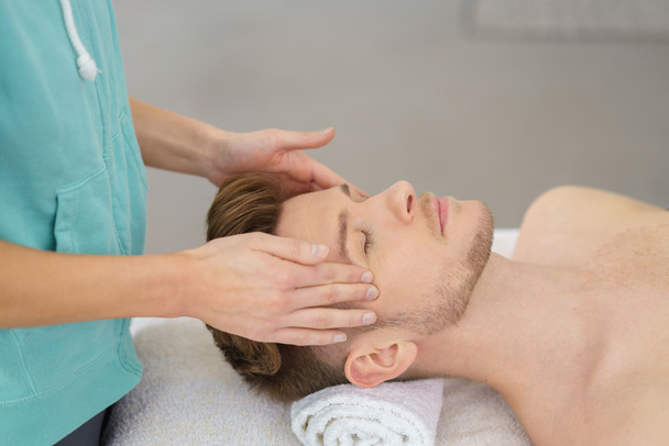man enjoying a facial massage - Fotoğraf, Görsel