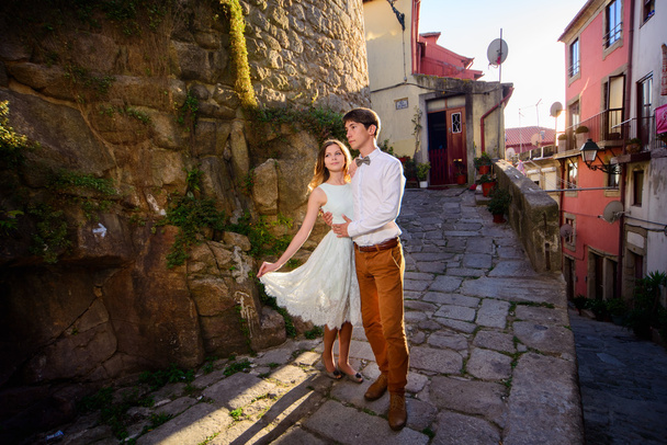 Happy young couple stands on background Porto - Zdjęcie, obraz