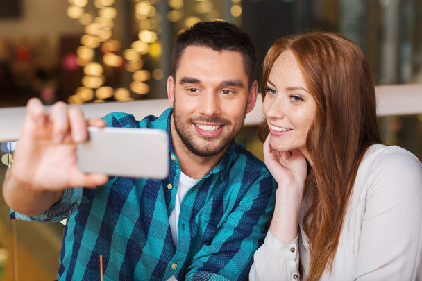 couple taking selfie by smartphone at restaurant - Photo, Image