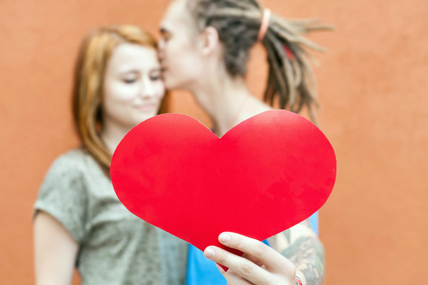 Happy Valentines Day couple holding red heart symbol - Φωτογραφία, εικόνα