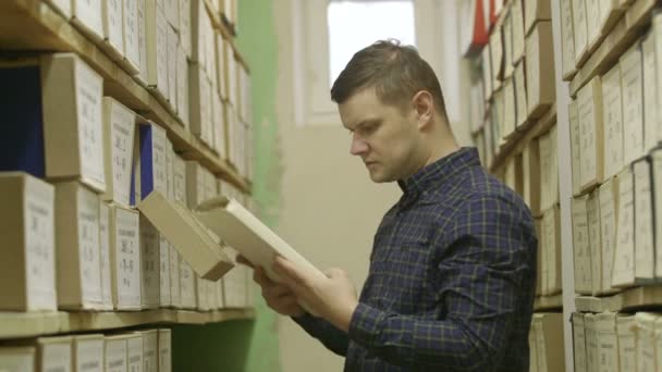 man looking documents in the archive. 3 shot - Video, Çekim