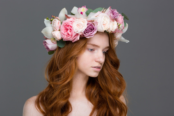 Beautiful tender woman with long hair in wreath of roses  - Fotó, kép