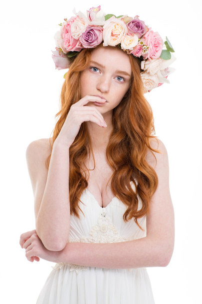 Beautiful redhead woman with wreath from flowers on head - Фото, изображение
