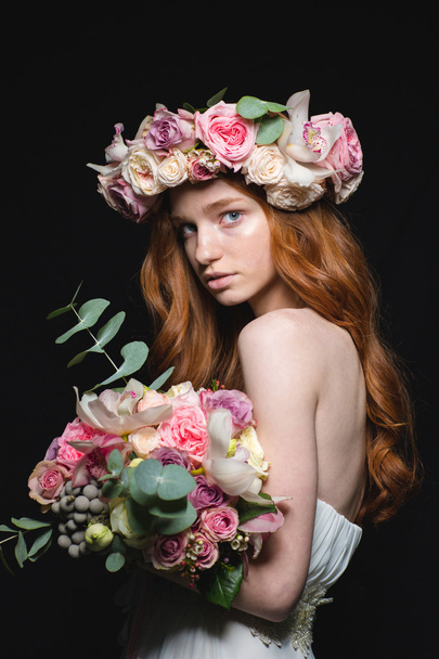 Beautiful redhead woman posing with flowers  - Foto, afbeelding