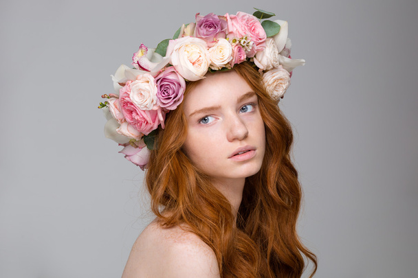 Beautiful tender woman with long hair in wreath of flowers - Fotó, kép