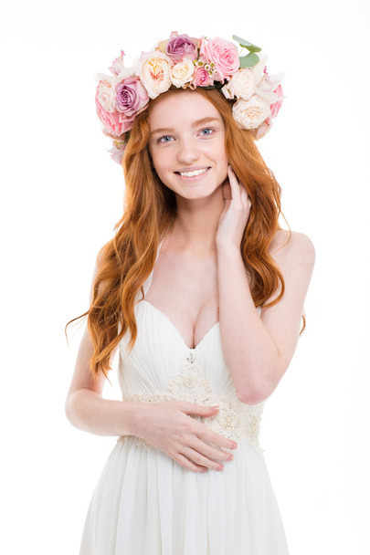 Happy redhead woman with wreath from flowers on head - Фото, изображение