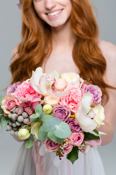 Cropped image of a woman holding flowers - Foto, afbeelding