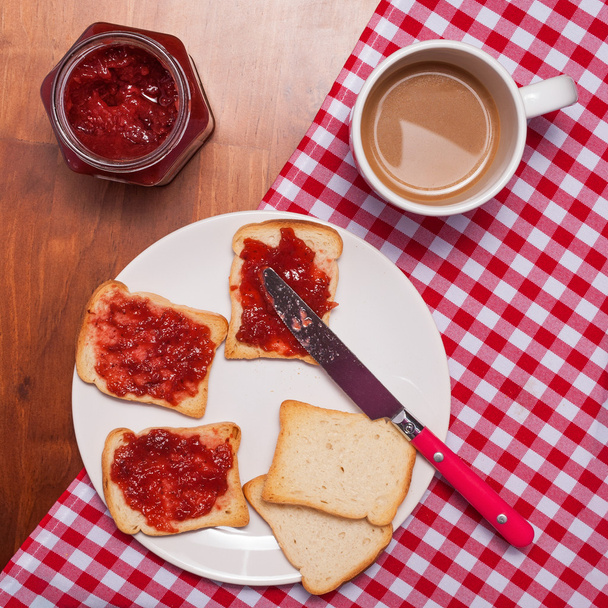 Toast with jam and cup of coffee on  wooden table, top view - Fotografie, Obrázek
