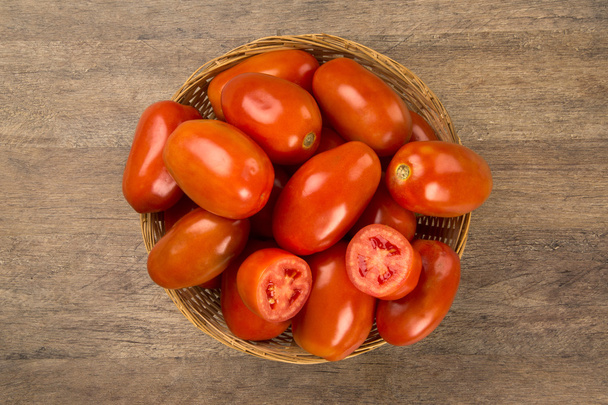 Some tomatoes over a wooden background. Fresh vegetable. - Foto, immagini