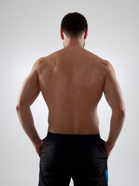 Muscular torso on gray - Фото, зображення