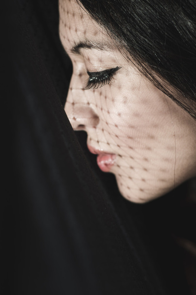 Headshot brunette model experimenting with shadows on obscure background, artistic dark beauty photo - Valokuva, kuva