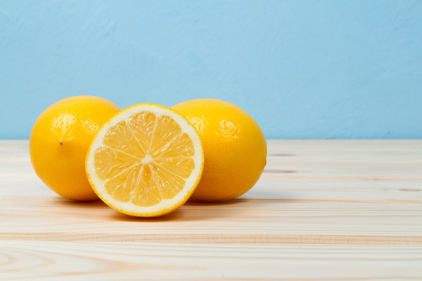 Bright yellow juicy lemons on  table. - Fotó, kép