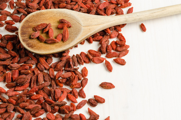 Goji berry dried in a dish, with spoon, closeup background - Valokuva, kuva